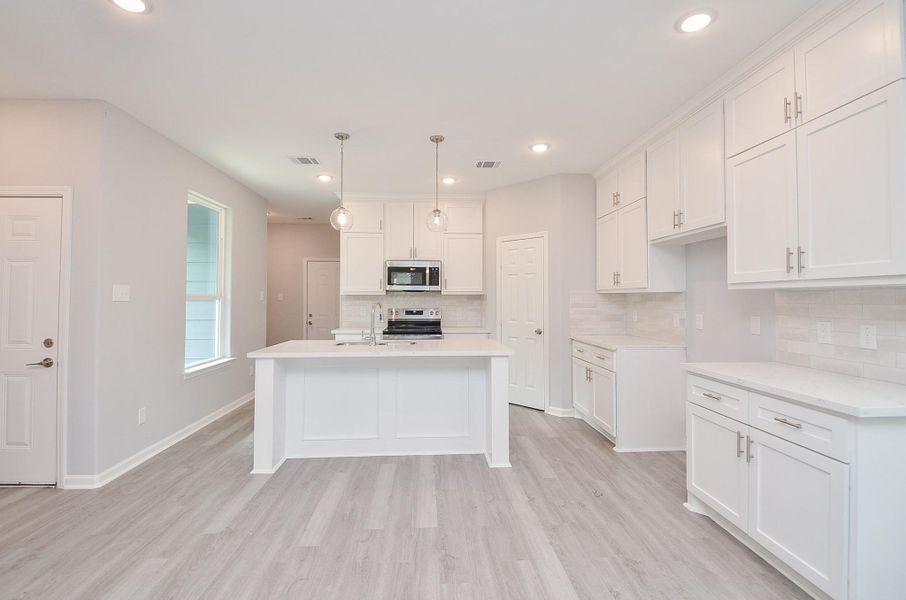 Bright kitchen with ample counters, great storage, and a functional layout that makes cooking a breeze.