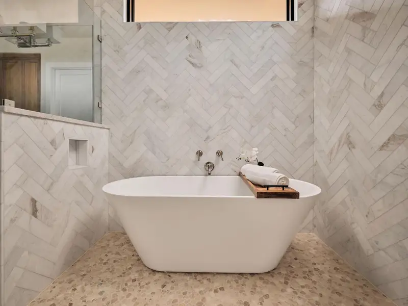 Freestanding soaking tub with elegant tile surrounds creates a private, restorative retreat. Freestanding soaking tub with elegant tile surrounds creates a private, restorative retreat.
