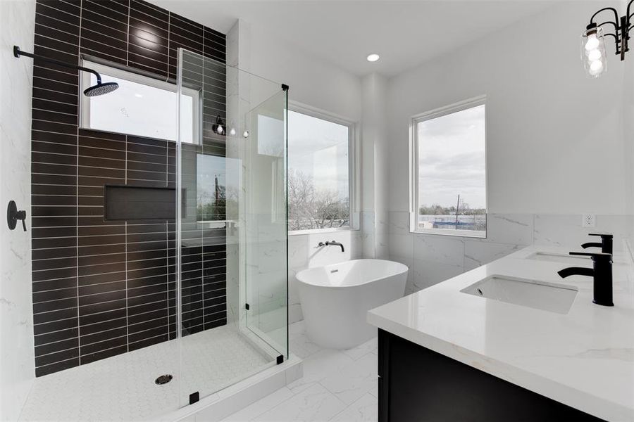 Beutiful tile and cabinetry contrast in the primary bathroom