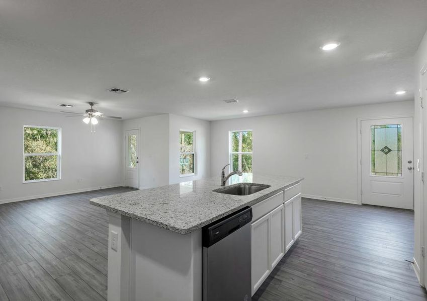 The kitchen island looks out over the family room