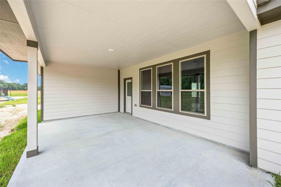 Expansive covered patio ready for grilling, relaxing, and outdoor entertaining with room to make it your own.