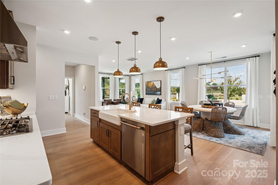 Large center island grounds the space and creates the perfect base for entertaining or casual dining. *Model Photos | actual finishes, structural selections, and orientation may vary.