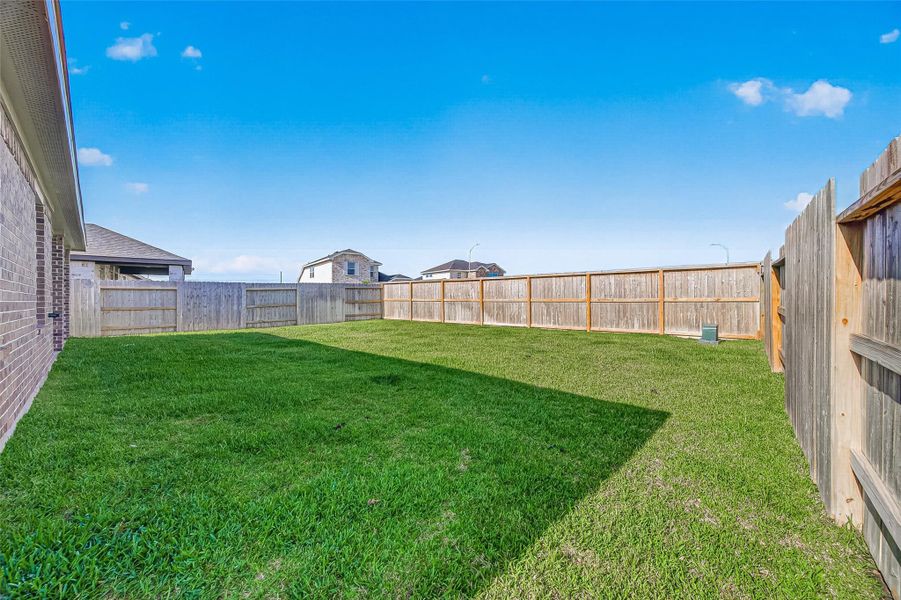 Exterior details and patio area of a home in Sunterra, Katy (Image 24).
