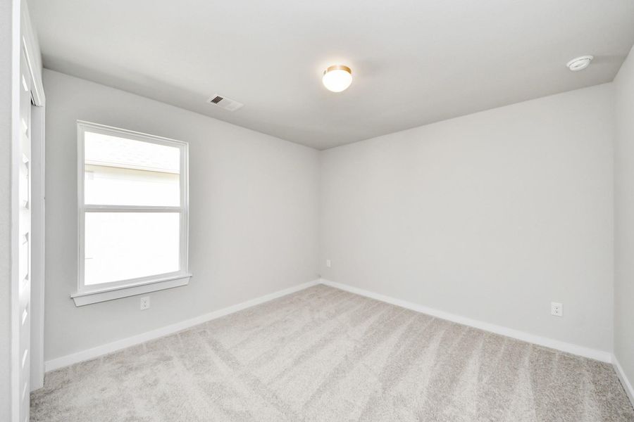 Secondary bedroom features plush carpeting, large windows that let in plenty of natural light, bright paint, and spacious closets. Secondary bedroom features plush carpeting, large windows that let in plenty of natural light, bright paint, and spacious closets.