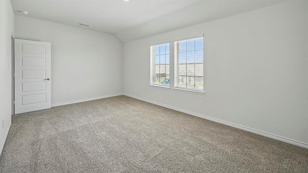 Carpeted room featuring dual windows with blinds, a five-panel interior door, and recessed lighting