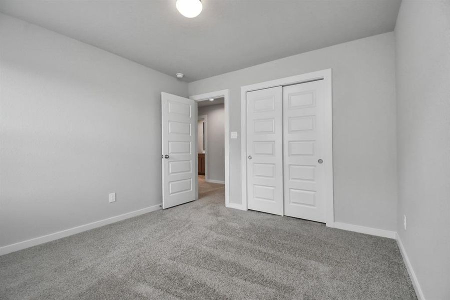 Generously sized secondary bedrooms featuring spacious closets, soft and inviting carpeting underfoot, large windows allowing plenty of natural light, and the added touch of privacy blinds for your personal retreat.