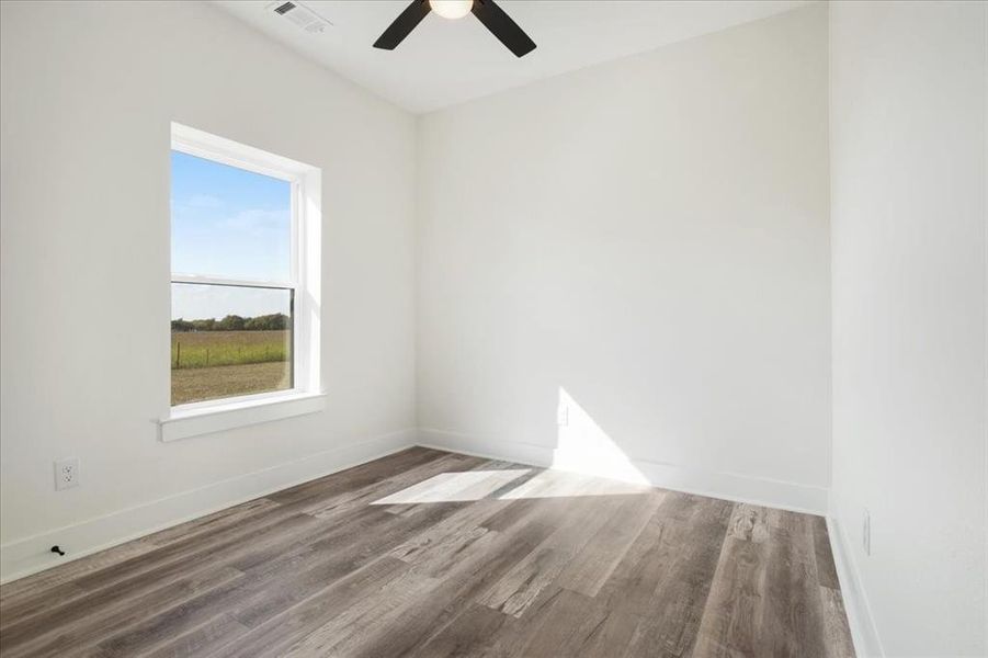 Bedroom 3 featuring wood-style finished floors and a ceiling fan