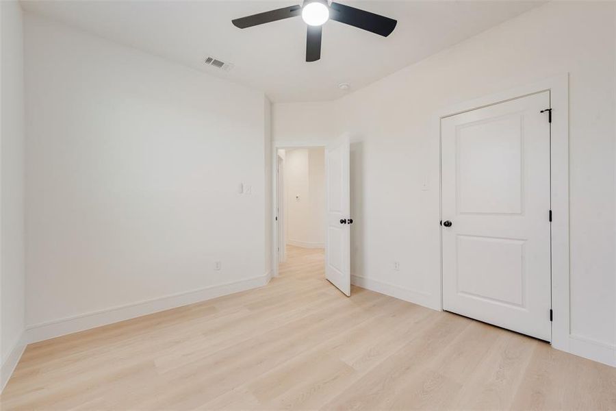 Unfurnished bedroom featuring ceiling fan and light hardwood / wood-style floors