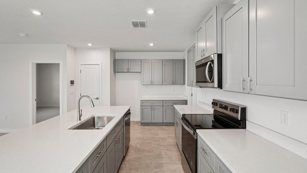 Kitchen and Large Island of the Jupiter in Hamilton Bluff located in Haines City, FL.