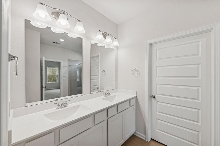The Cardinal II- Primary Bathroom with Dual Vanities. Photos of home shown are for illustration only; actual features, colors, and upgrades may vary. The Cardinal II- Primary Bathroom with Dual Vanities. Photos of home shown are for illustration only; actual features, colors, and upgrades may vary.