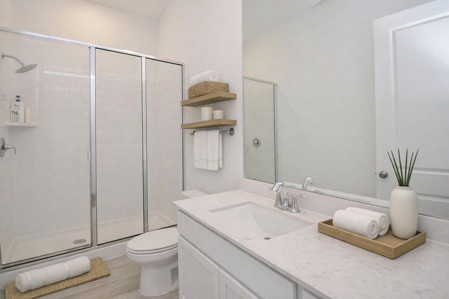 Full bath down with huge walk in shower and generous cabinet space and tile floors