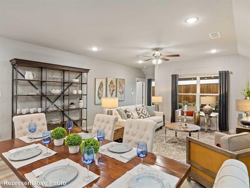 Living room featuring vaulted ceiling, ceiling fan, and hardwood / wood-style floors