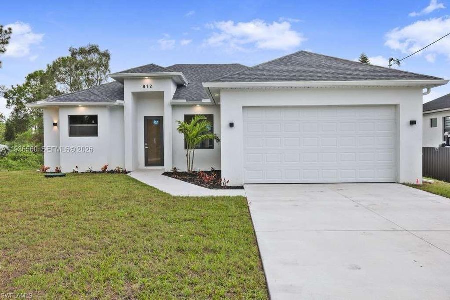 Front exterior of a new home in , Lehigh Acres, FL, highlighting curb appeal (Image 1). Front exterior of a new home in , Lehigh Acres, FL, highlighting curb appeal (Image 1).