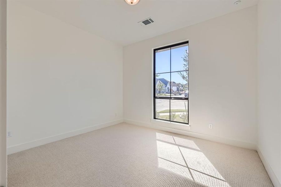 Spare room featuring a healthy amount of sunlight and light colored carpet