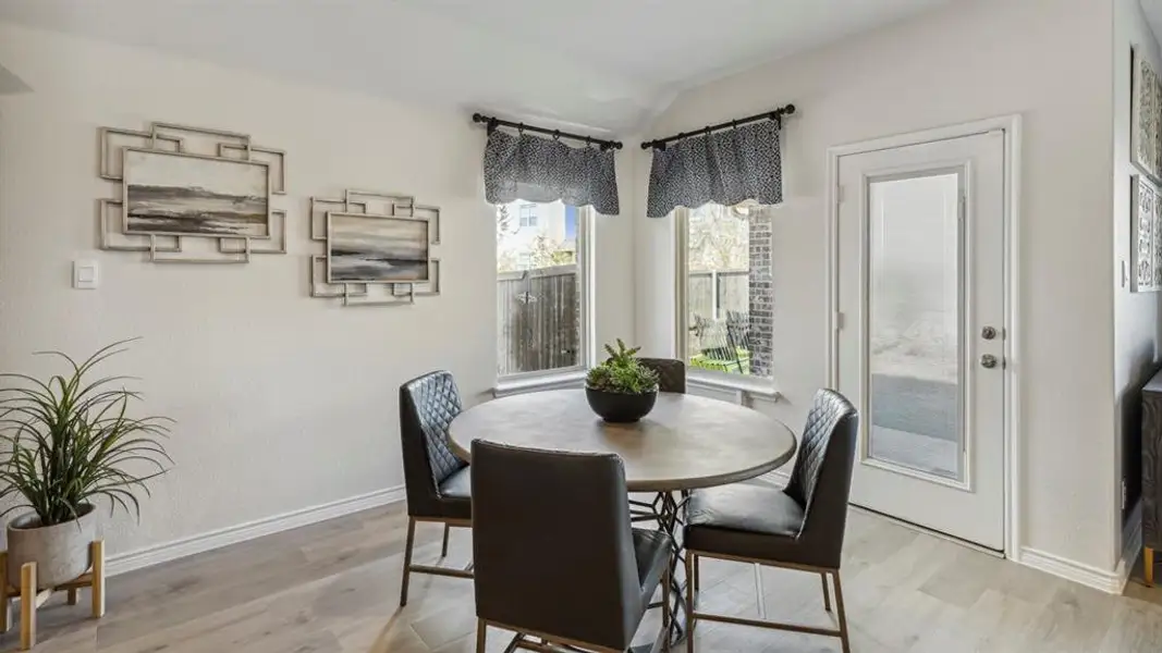 This dining area features light-colored walls and light wood-look flooring