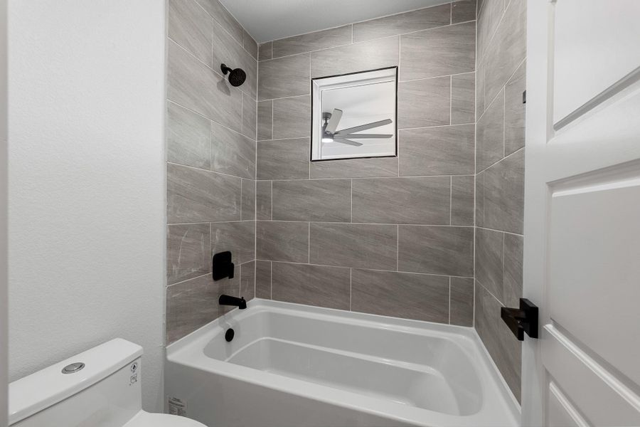 Elegant custom tile enhances the Jack and Jill bathroom. Elegant custom tile enhances the Jack and Jill bathroom.