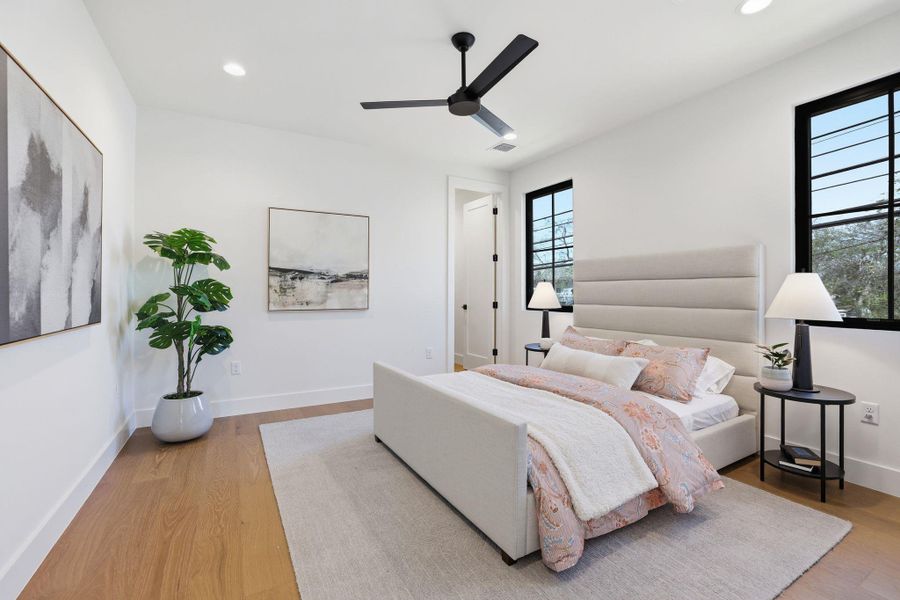 Bedroom featuring ceiling fan, light wood finished floors, and recessed lighting