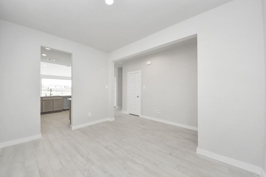 Create lasting memories with your family and friends at the dining table! This expansive dining room showcases sophisticated flooring, custom paint, and seamlessly connects to the family room and kitchen, providing an open and inviting atmosphere. Create lasting memories with your family and friends at the dining table! This expansive dining room showcases sophisticated flooring, custom paint, and seamlessly connects to the family room and kitchen, providing an open and inviting atmosphere.