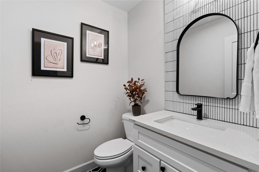 The powder room sits conveniently along the staircase, making it easily accessible for guests.