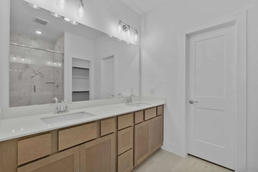 Representative furnished interior of a home built from the Chalet by Chesmar Homes in Meridiana Townhomes, Iowa Colony (Image 10).