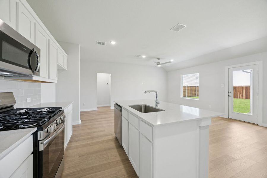 Kitchen in the Hadley home plan by Trophy Signature Homes – REPRESENTATIVE PHOTO Kitchen in the Hadley home plan by Trophy Signature Homes – REPRESENTATIVE PHOTO