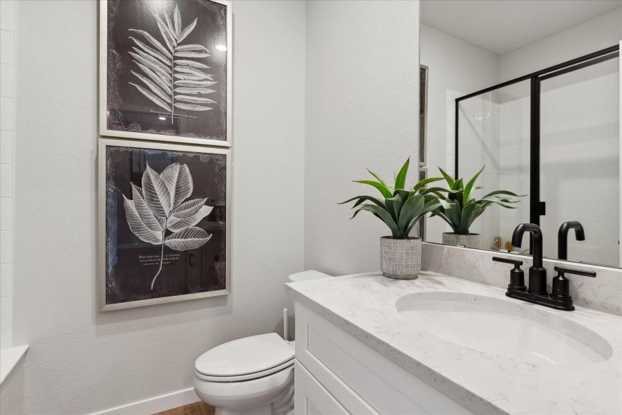 A bathroom with a sink and a toilet. A bathroom with a sink and a toilet.