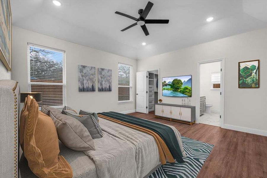 Bedroom featuring connected bathroom, a walk in closet, wood-type flooring, and ceiling fan