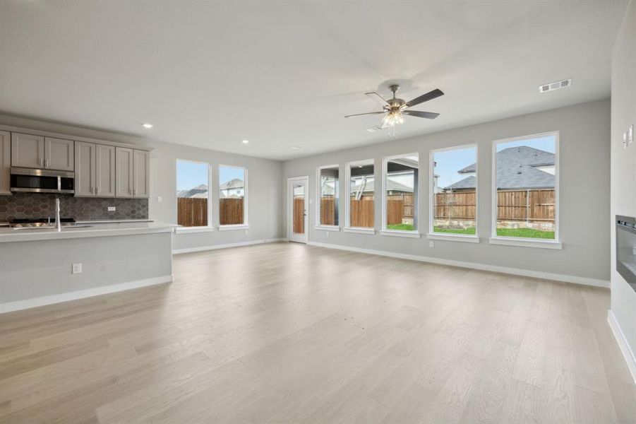 This view of the living room shows the dining space next to the kitchen