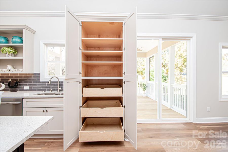 Offers abundant storage, including soft-close pull-out drawers for added convenience.