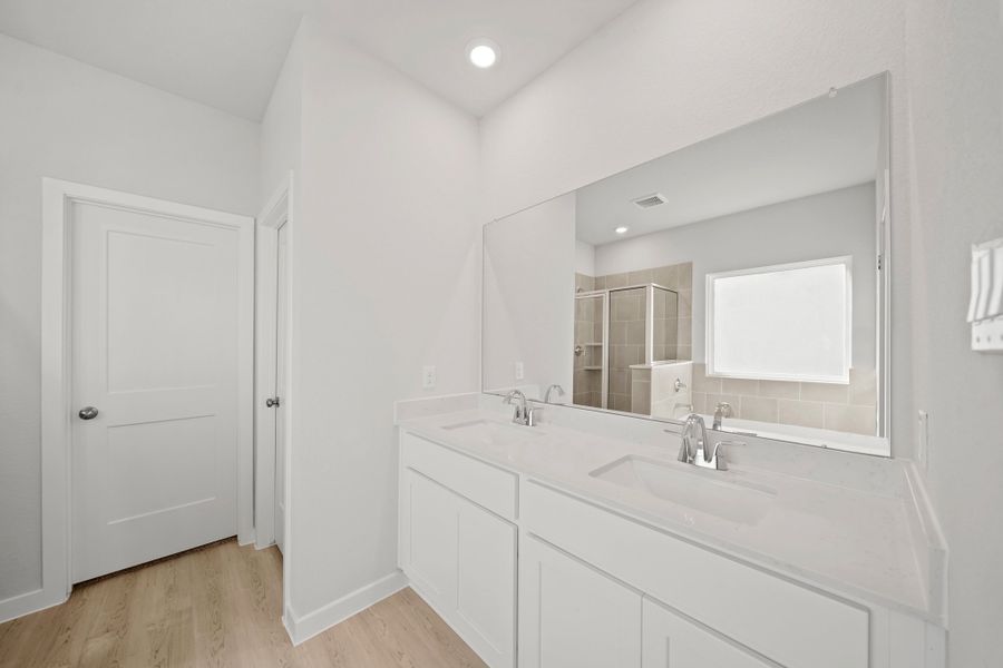 A bathroom with white cabinets. A bathroom with white cabinets.