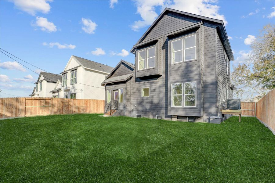 Spacious backyard is fully fenced (grass has been digitally added).
