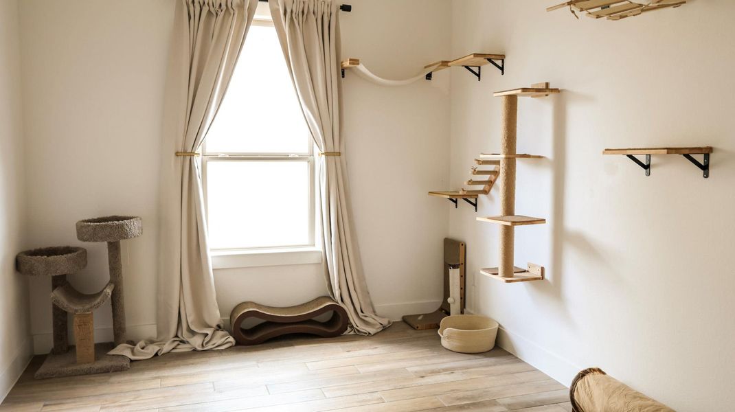 Sun-filled room boasts hard surface flooring and clean white walls, awaiting personalized touches. Sun-filled room boasts hard surface flooring and clean white walls, awaiting personalized touches.