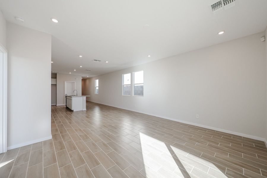 A large empty room with a wood floor and white walls. A large empty room with a wood floor and white walls.