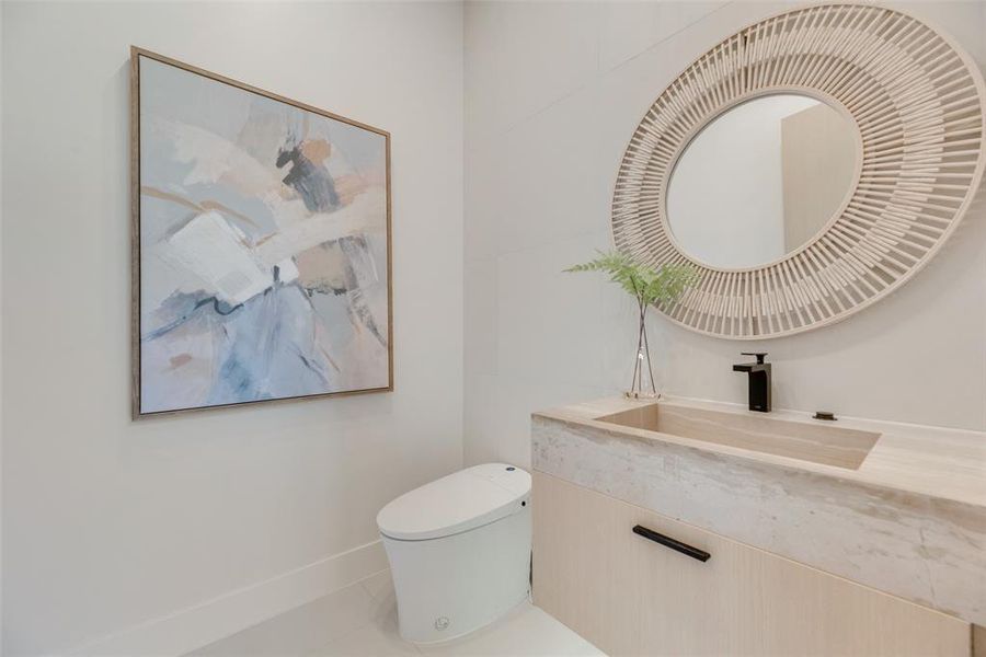 Bathroom featuring tile patterned floors, vanity, and toilet