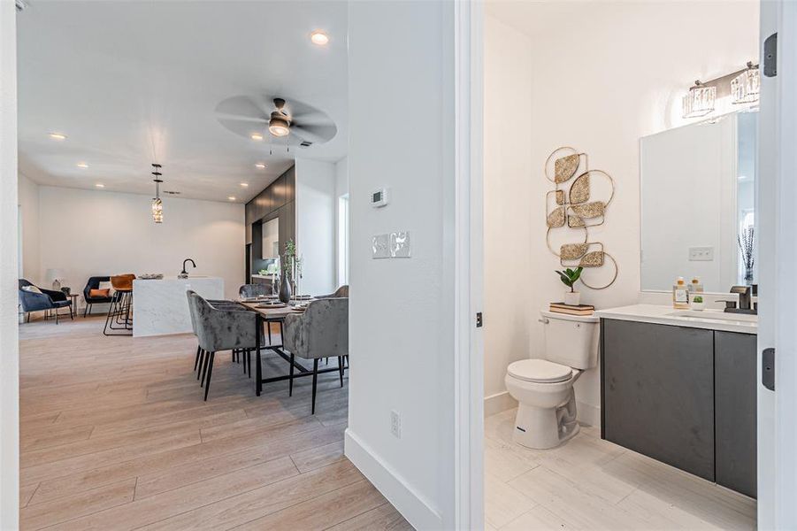 Half bathroom featuring vanity, recessed lighting, light wood finished floors, and ceiling fan Half bathroom featuring vanity, recessed lighting, light wood finished floors, and ceiling fan