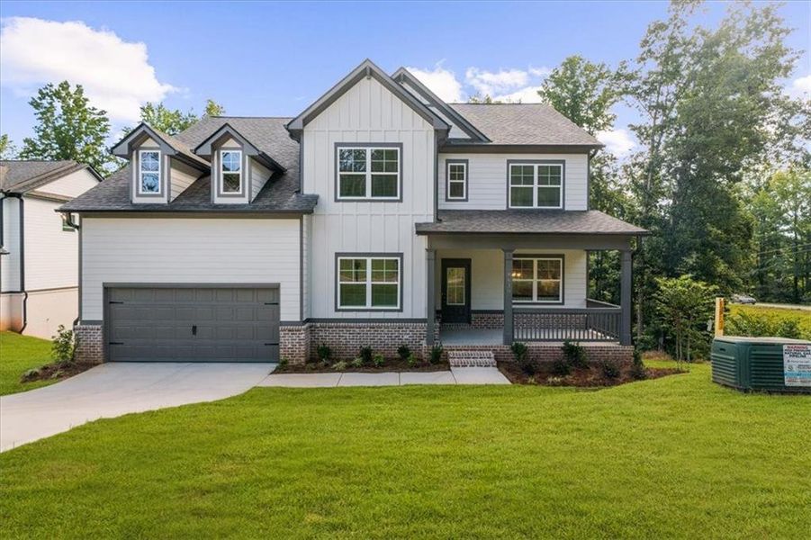 Front exterior of a new home in River Rock, Ball Ground, GA, highlighting curb appeal (Image 28).