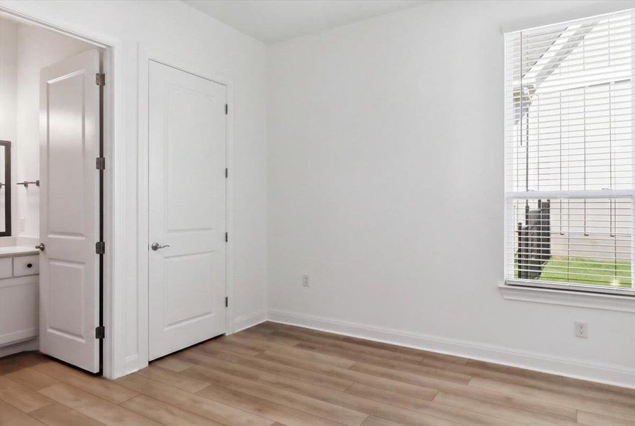 Hardwood-style flooring and a bright window create an inviting secondary bedroom or flexible living space. Hardwood-style flooring and a bright window create an inviting secondary bedroom or flexible living space.
