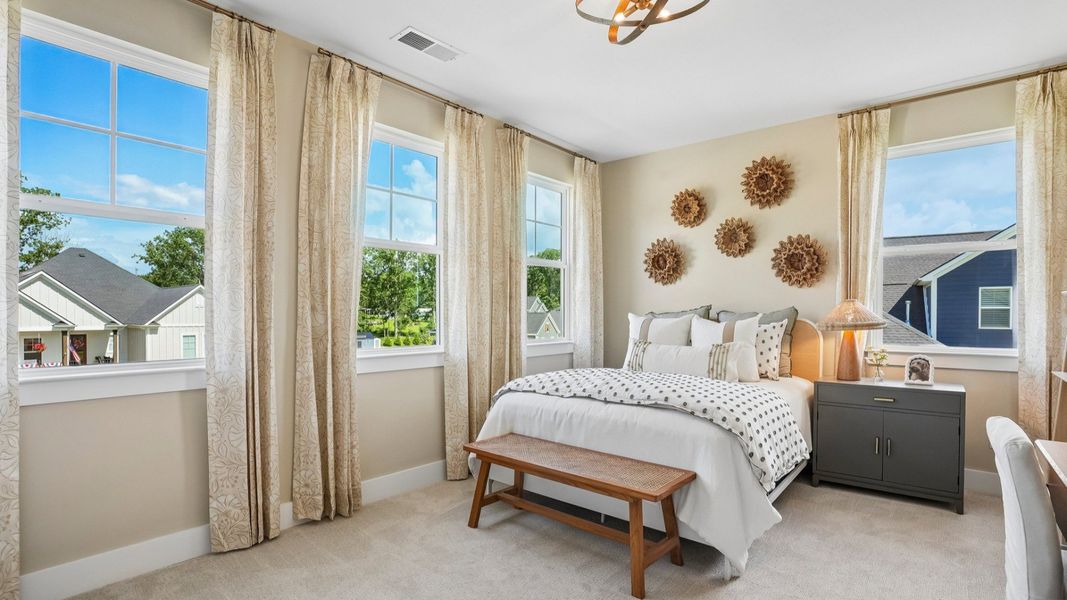 Secondary bedroom with natural lighting from windows and carpet Secondary bedroom with natural lighting from windows and carpet