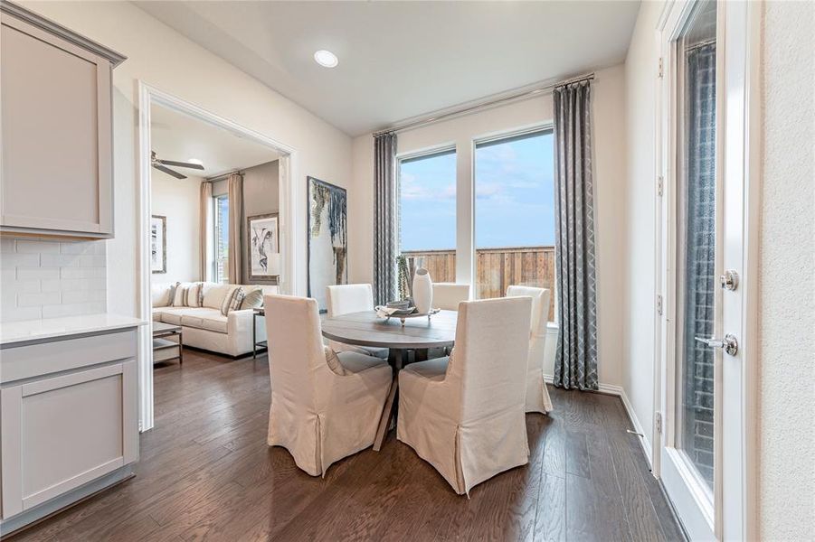 Dining room featuring dark wood-type flooring, ceiling fan, and recessed lighting