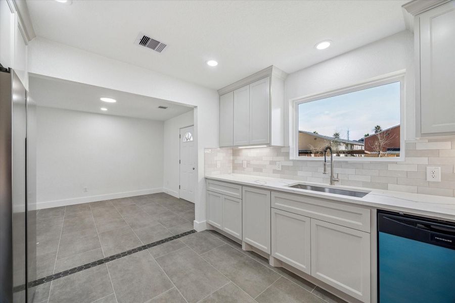 Additional view of kitchen and dining area. Stainless steel refrigerator (left) included!