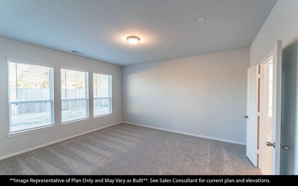 A serene primary retreat bedroom is designed for comfort and calm. Soft natural light and a spacious layout create the perfect atmosphere for rest and relaxation at the end of the day.  French doors leading into the spa bathroom **Image Representative of Plan Only and May Vary as Built**.