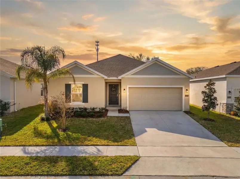 Front exterior of a new home in Vineland Reserve, Osteen, FL, highlighting curb appeal (Image 23).
