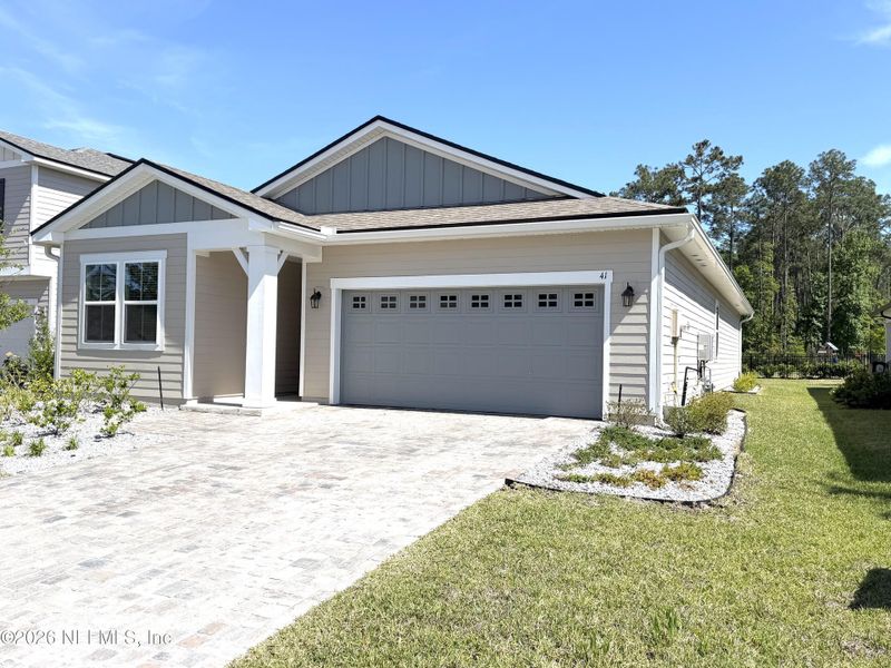 Front exterior of a new home in Seasons at TrailMark, St. Augustine, FL, highlighting curb appeal (Image 30).