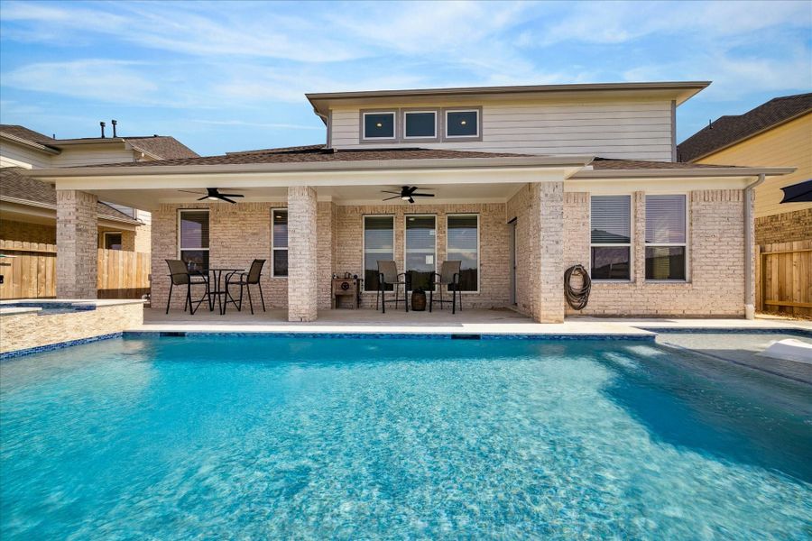 Stunning backyard with a sleek in-ground heated saltwater pool, lounging area, and a privacy fence. Stunning backyard with a sleek in-ground heated saltwater pool, lounging area, and a privacy fence.