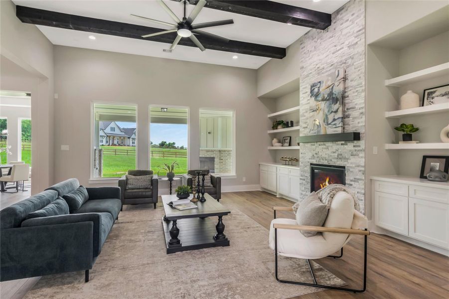 Modern design with high ceilings, exposed beams, and a stone fireplace. Modern design with high ceilings, exposed beams, and a stone fireplace.
