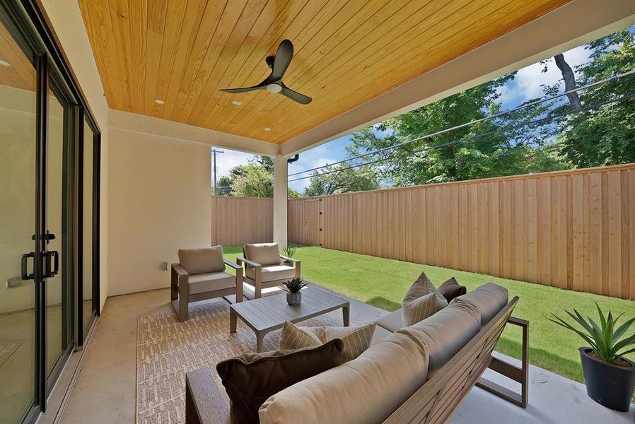 Covered patio featuring a wood-panel ceiling and recessed lighting