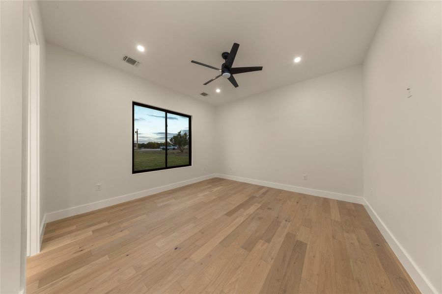 Unfurnished room featuring light wood-style floors, a ceiling fan, and recessed lighting