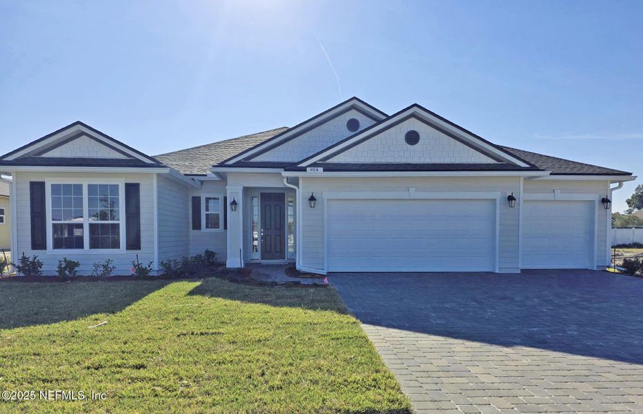 Front exterior of a new home in Sandy Ridge, Yulee, FL, highlighting curb appeal (Image 1).