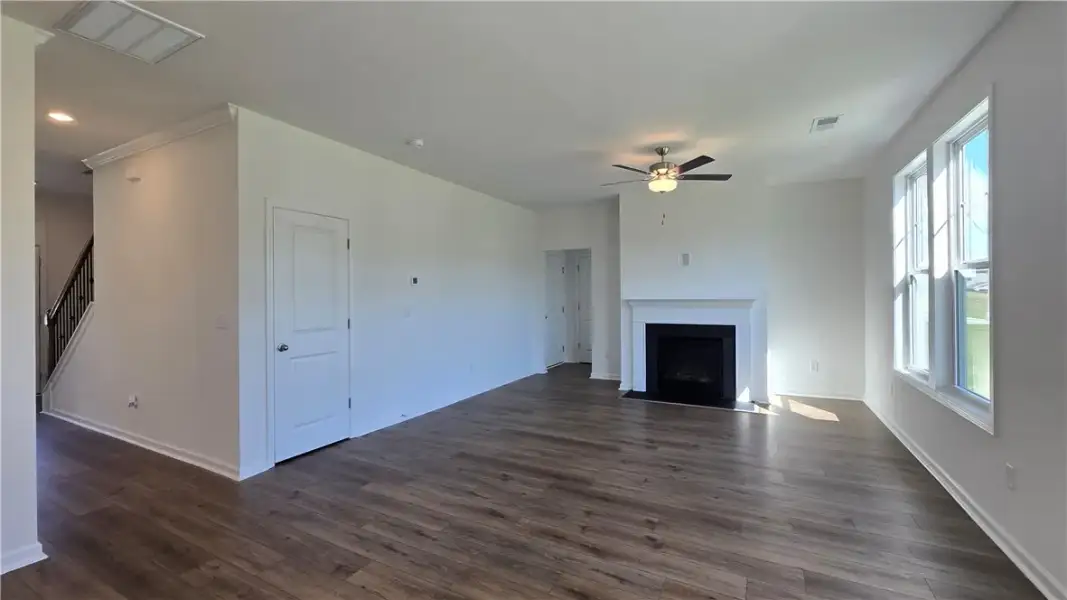 Rich wood-inspired flooring and a classic fireplac