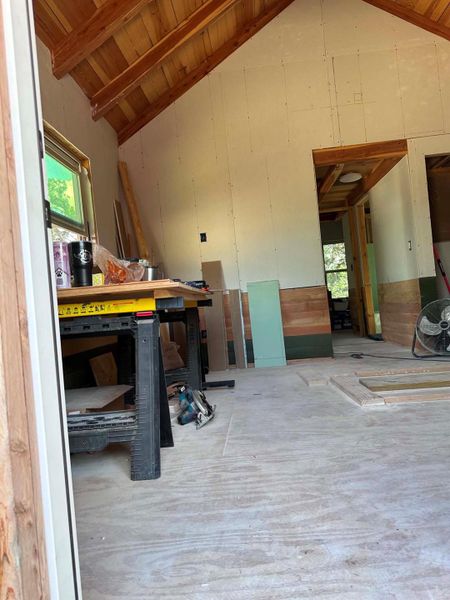 A glimpse of potential, with exposed wooden beams and a framed-in window ready for completion.
